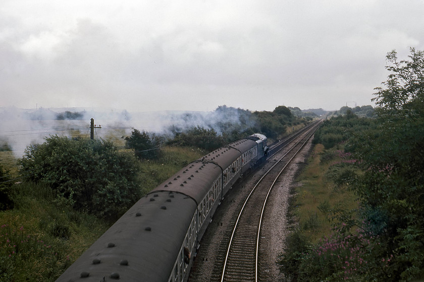 4498, outward leg of The Cumbrian Coast Express, 10.23 Blackpool North-Sellafield, Lindal SD262764 
 A pretty ordinary going-away shot of 4498 'Sir Nigel; Gresley' taking The Cumbrian Coast Express up Lindal Bank in the southern Lakes. The A4 is producing more exhaust this time but, unfortunately, this is somewhat camouflaged by the matching grey sky! The train continued its journey, avoiding Barrow-in-Furness and terminating at Sellafield ready for 5690 'Leander' to bring the train back. 
 Keywords: 4498,The Cumbrian Coast Express 10.23 Blackpool North-Sellafield Lindal SD262764