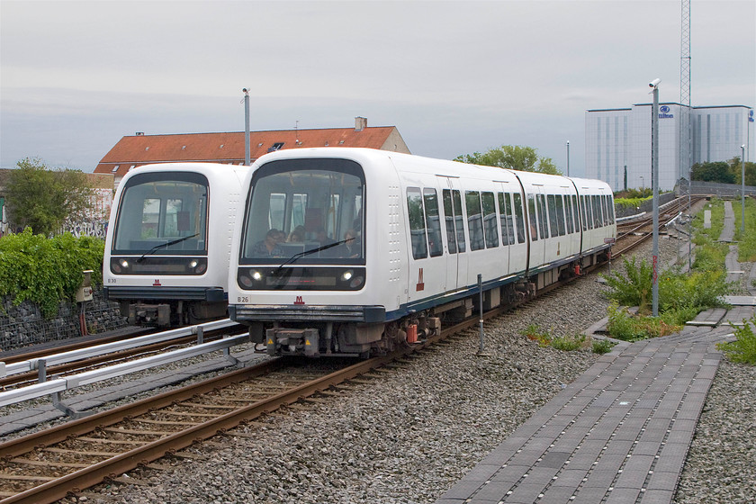 B30, stabled & B26, Lufthnaven-Vanlse working, Kastrup station 
 At Kastrup Metro station B26 arrives with a Lufthnaven to Vanlse working. We took this service to Christianshavn. Behind the arriving train is B30 stabled. Note that the Metro train are driverless operating in a similar manner to our own DLR. It is double track throughout and has been a twenty forur hour operation since 2009. 
 Keywords: B30 B26 Lufthnaven-Vanlse Kastrup station