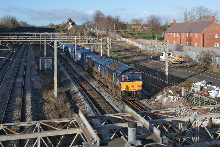 66427, 13.09 DIRFT-Tilbury (4L48,4L), site of Roade station 
 66427 emerges from the deep shadows of Roade cutting working the 4L48 13.09 Daventry to Tilbury Tesco Express. This particular Class 66 is one of my photographed examples with a quick search of my website finding it recorded on this train a number of times as well as at various other locations around the country. 
 Keywords: 66427 13.09 DIRFT-Tilbury 4L48 site of Roade station Daventry Tesco Express