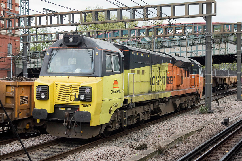 70807, stabled, Royal Oak LU station 
 Network Rail had a possession of some of the commuter lines and platforms at Paddington in connection with engineering works that would take place over the Easter bank holiday weekend. As a ballast train makes its way slowly past Royal Oak LU station 70087 sits stabled for its next job. 
 Keywords: 70807 Royal Oak LU station