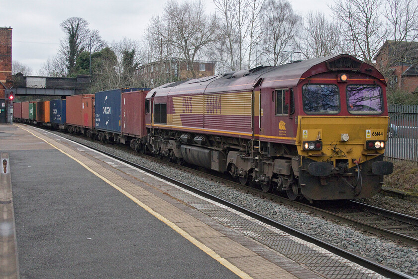 66144, 05.47 Wakefield Europort-Souhampton Western Docks (4O43, 3E), Watwer Orton station 
 It seemed a bit of a cold morning for the driver of 66144 to have the cab door open but both the front and rear doors were both wide open! The 4O43 05.47 Wakefield Europort to Southampton Western Docks passes through Water Orton on this particularly dull and chilly morning. Notice the white rectangle of paint applied to the overbridge. This will have been to have aided sighting when there were semaphore signals in place. 
 Keywords: 66144 05.47 Wakefield Europort-Souhampton Western Docks (4O43, 3E), Water Orton station