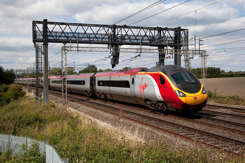 390153, VT 12.47 Liverpool Lime Street-London Euston (1A30, 7L), Ashton Hill 
 Virgin Trains 390153 'Mission Accomplished' passes Ashton Hill between Northampton and Wolverton with the 12.47 Liverpool to Euston working. This is a super spot to photograph trains from about lunchtime onwards but only if you have a ladder to get above the palisade fencing. 
 Keywords: 390153 1A30 Ashton Hill