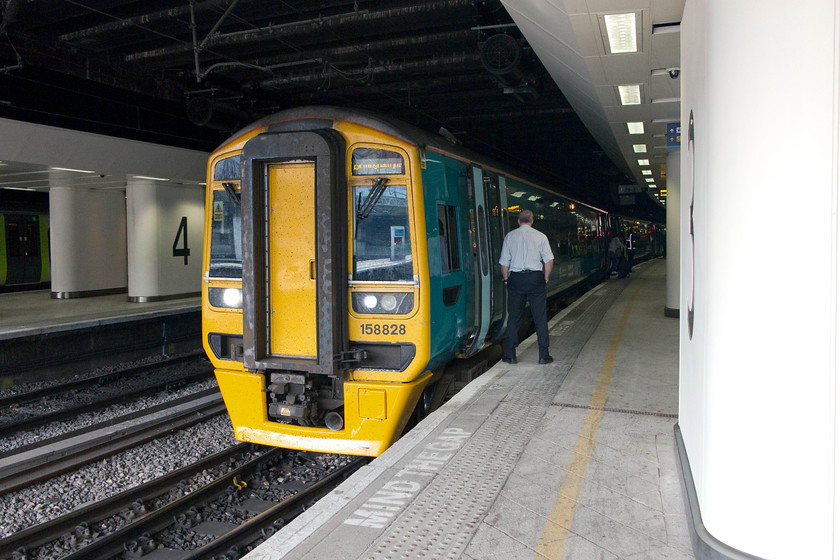 158828, AW 07.47 Wrexham General-Birmingham International (1G93), Birmingham New Street station 
 158828 has it nose just illuminated by the daylight inside Birmingham New Street station. It has just stopped working the ATW 07.47 Wrexham General to Birmingham International service. As the last passengers board, the guard's hands are thrust impatiently in his pockets with the train ready to go! 
 Keywords: 158828 07.47 Wrexham General-Birmingham International 1G93 Birmingham New Street station