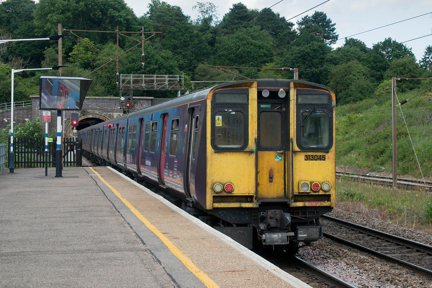 313045, GN 13.30 Moorgate-Welwyn Garden City (2V75, 1E), Hadley Wood station 
 313045 leaves Hadley Wood station at the rear of the 13.30 Moorgate to Welwyn Garden City. This could possibly be one of the last times that I will photograph these 1976-1977 built dual voltage electrics as withdrawal is now halfway through. I remember when I first travelled in one from King's Cross to Finsbury Park back in 1978 and thinking that they were so modern and up to date with their sliding doors! 
 Keywords: 313045 13.30 Moorgate-Welwyn Garden City 2V75 Hadley Wood station