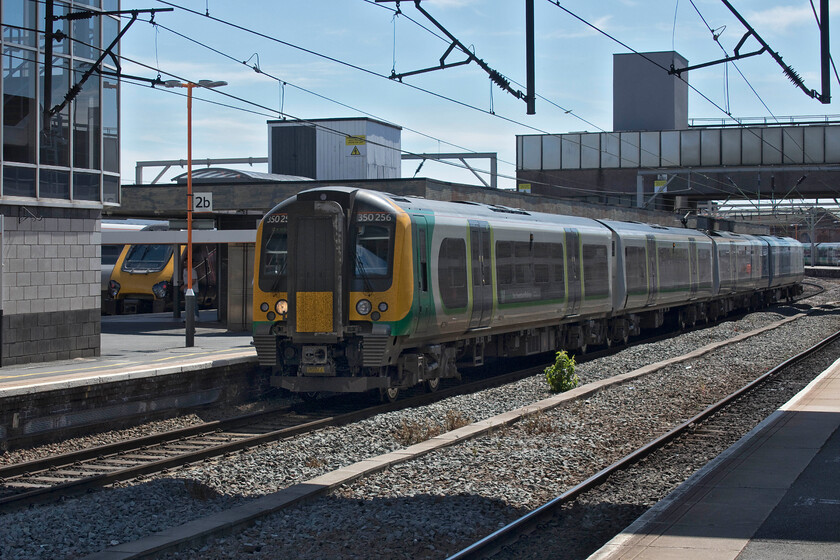 350256, LN 11.22 Birmingham New Street-Crewe (2K48, 2L) & 221133, XC 10.27 Manchester Piccadilly-Reading (1O14, 1E), Wolverhampton station 
 A busy scene at Wolverhampton station. With a London bound Pendolino to the far side CrossCountry's 221113 leaves working the 1O14 10.27 Manchester to Reading service. In the foreground 350256 waits to leave working the 11.22 New Street to Crewe local stopper. For such a busy and principal station I find Wolverhampton a cramped place that seems to be in a perpetual state of construction or alteration. That was no exception on the day of our visit with the entrance area being re-built. 
 Keywords: 350256 11.22 Birmingham New Street-Crewe 2K48 221133 10.27 Manchester Piccadilly-Reading 1O14 Wolverhampton station CrossCountry Voyager London Northwestern Desiro