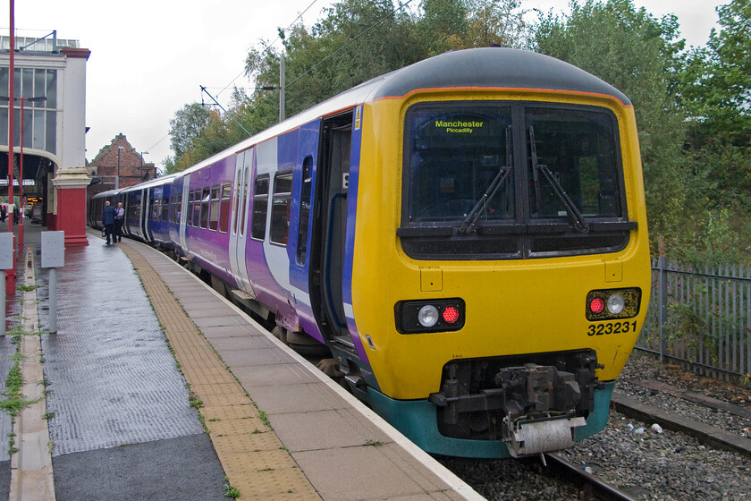 323321, NT 10.59 Stoke-on-Trent-Manchester Piccadilly (2H17), Stoke-on-Trent station 
 Waiting in Stoke's north-facing bay platform 323321 will soon work the 10.59 stopper service to Manchester Piccadilly. Notice the crew who will work the train, that will leave in some ten minutes, having a chat by the middle coach of three-car unit. 
 Keywords: 323321 10.59 Stoke-on-Trent-Manchester Piccadilly 2H17 Stoke-on-Trent station Northern Trains