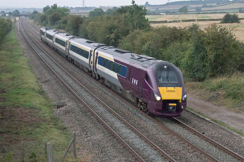 222009 EM 07.12 Nottingham-London St. Pancras (1B16, 1E), Braybrooke SP769849 
 The 07.12 Nottingham to St. Pancras EMR service passes Braybrooke just south of Market Harborough worked by 222009. The light was so dire at this location with some very threatening grey clouds pushing in from the northwest that I had to ramp up the camera's ISO to an eye-watering 8000 and that was only using a shutter speed of 1/1600 of a second - and this is the third week of August! 
 Keywords: 222009 07.12 Nottingham-London St. Pancras 1B16 Braybrooke SP769849 EMR Meridian