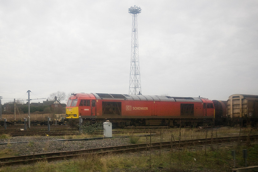 60063, stabled, Bescot Yard 
 Another mediocre picture taken through the train window as it passed through Bescot yard. It shows 60063 at the head of a stabled tanker train. As a young spotter in the 1970s I would often wish that our car would get a puncture as we travelled along the elevated section of the M6 that overlooked the yard so that I could get the numbers of the many stabled locomotives. The situation today is not so exciting with many fewer loco. on-shed but it remains a busy West Midlands hub of railway activity. 
 Keywords: 60063, stabled, Bescot Yard