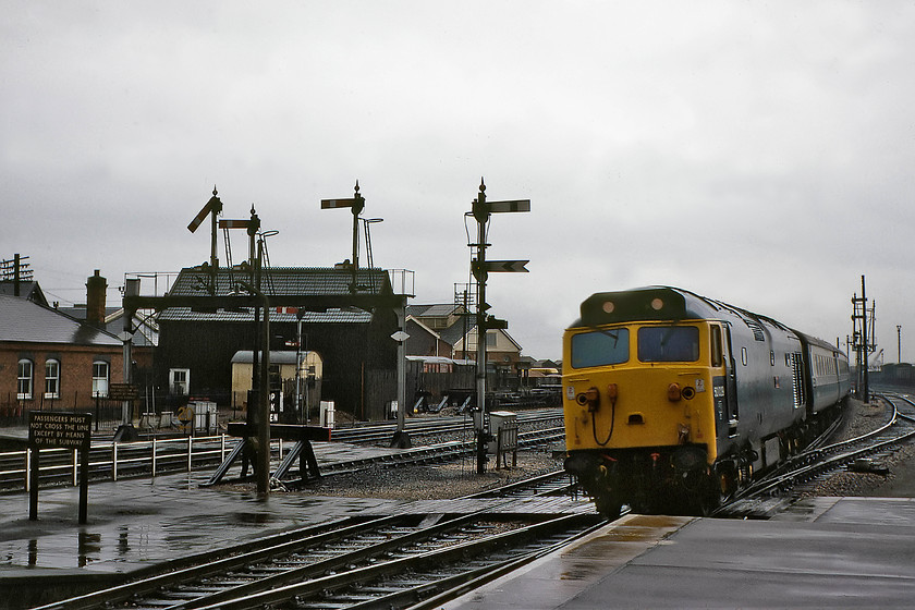 50029, 17.32 London Paddington-Penzance (1B22), Taunton station (Courtesy of GGV) 
 The Class 50 and the Mk. II stock is the most modern pieces of railway hardware in evidence here at the eastern end of Taunton station! The wet and very dull scene is full of Great Western infrastructure and illustrates an era of the railways now long confined to history. There are so many things to take one's fancy here but my favourite has to bthe corrugated iron tin hut that appears to be still painted in some variant of chocolate and cream. 50029 'Renown' brings the 1B22 17.32 Paddington to Penzance into the station. This picture is courtesy of Graham, this slide did not make the final cut in his collection. 
 Keywords: 50029 17.32 London Paddington-Penzance, Taunton station