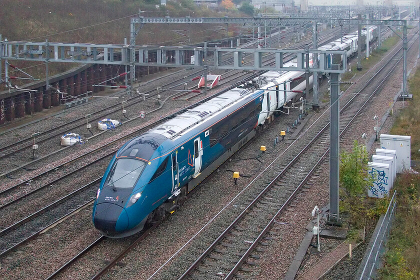 805012, 10.05 London Euston-Crewe (3K72, 6E), Loughton Redway bridge, Milton Keynes 
 Testing times still for the Class 805 Averos! Having been in service for some months now a number of the sets are still undertaking testing, staff training and, mileage accumulation. On a foggy and damp October morning 805012 passes Milton Keynes, seen from the Loughton Redway bridge, working the 3K72 10.05 Euston to Crewe train that would return later in the early afternoon. 
 Keywords: 805012 10.05 London Euston-Crewe 3K72 Loughton Redway bridge Milton KeynesAWC Avanti West Coast avero