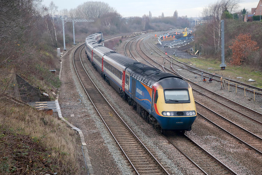 43050 & 43044, EM 10.45 Nottingham-London St. Pancras (1B33, 3E), Headlands bridge 
 HST powers cars 43050 and 43044 work the 10.45 Nottingham to St. Pancras service through Kettering. The picture is taken from Headlands footbridge that has recently been 'upgraded' to accommodate the electrification wires. Unfortunately, in common with their normal practice, Network Rail have installed huge green anti-suicide parapets making photography impossible unless one stands on a ladder. This means that whenever I go out now and I'm not on my bike, I carry 'Stulio the step ladder'. Notice in the background the reinstatement of the sidings being performed by yet more of the orange army. 
 Keywords: 43050 43044 10.45 Nottingham-London St. Pancras 1B33 Headlands bridge