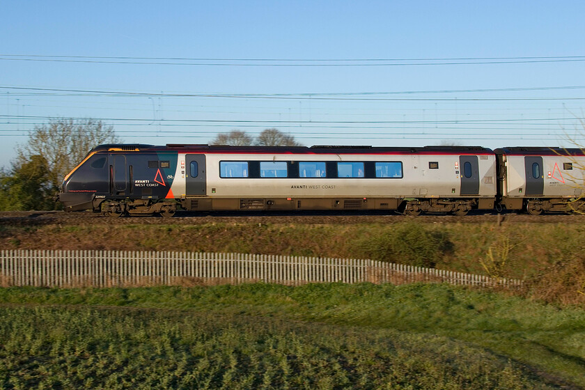 221107, VT 05.52 Birmingham New Street-London Euston (1R02, 22L), between Roade & Ashton 
 With the Weedon line mysteriously closed overnight and with this closure still in place by morning trains were feeling the effect of this with them being diverted via Northampton and considerable time being added to their journeys. 221107 is the lead set of the 1R02 05.52 Birmingham to Euston service passing just south of Roade which should be between Tring and Berkhamsted by this time! 
 Keywords: 221107 05.52 Birmingham New Street-London Euston 1R02 between Roade & Ashton AWC Avanti West Coast Voyager