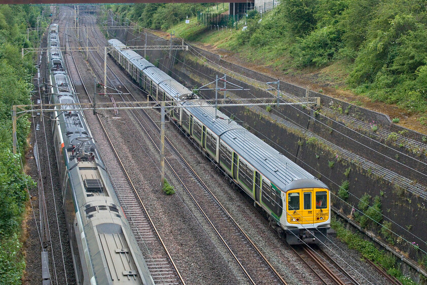 319457 & 319433, 15.29 Northampton EMD-Bletchley CS (5B99, 5E) & 390137, VT 14.47 London Euston-Manchester Piccadilly (1H27, 8L), Roade cutting 
 Whilst I have a number of photographs of London Northwestern's small fleet of retained Class 319s very few of them actually are of the trains in service. This one is no exception being of the 15.29 Northampton EMD (Siemens at Kings Heath) to Bletchley Carriage Sidings ECS move worked by 319457 and 319433. However, taking any photographs of these units is worth making an effort for as their demise is imminent with the new but troublesome in testing Class 730s entering service soon. In this photograph in Roade cutting, Avanti's 390137 also speeds north working the 14.47 Euston to Manchester Piccadilly service. 
 Keywords: 319457 319433 15.29 Northampton EMD-Bletchley CS 5B99 390137 14.47 London Euston-Manchester Piccadilly 1H27 Roade cutting London Northwestern AWC Avanti Pendolino