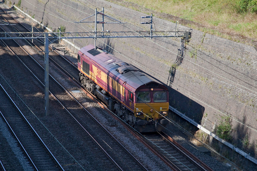 66068, 11.21 Peak Forest-Wembley LE, Roade Cutting 
 66068 runs on the up slow through Roade Cutting as the 11.21 Peak Forest to Wembley light engine move. Unfortunately, I could not find the reporting number of this particular working. This 66 arrived in the UK in February 1999 arriving at Newport Docks on the MV Fairmast. 
 Keywords: 66068 11.21 Peak Forest-Wembley Light engine Roade Cutting