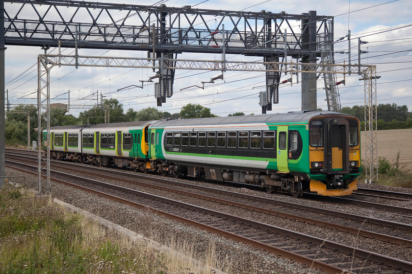 Class 150 & 153334, 14.45 Bletchley CS-Tyseley ECS (5Y30), Ashton Hill 
 Every Sunday there are two ECS moves between Tyseley and Bletchley. These ECS moves being when the Marston Vale (Bedford to Bletchley) stock is exchanged. Fresh units come from Tyseley that then work a weeks on the line to head back again the next weekend whilst more fresh coming south again. Here a class 150 and 153334 head along the down slow as the 5Y30 14.45 Bletchley Carriage Sidings to Tyseley past Ashton Hill just south of Roade. 
 Keywords: Class 150 153334 14.45 Bletchley CS-Tyseley ECS 5Y30 Ashton Hill