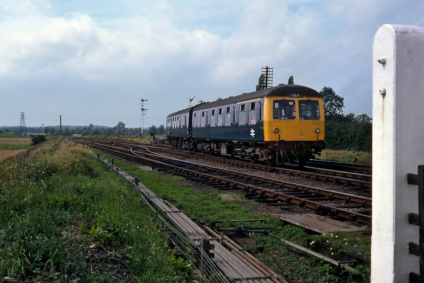 Class 105 DMU (E51286 & E56444), 12.38 Doncaster-Ely, Sleaford West 
 With the post of Sleaford's Castle Causway level crossing to the right, a Cravens Class 105 DMU enters the town working the 12.38 Doncaster to Ely service. E51286 leads E56444 off the one hundred and eighty degrees curve from Sleaford North Junction in order to reach the station rather than take the avoider. Of note in this photograph is the number of point rods in the foreground operated by Sleaford West signal box just to my right. Both the cars of this Cravens DMU did another ten years of service before withdrawal came in 1990 with the latter spending its final eight years as a route learner numbered TDB977125. 
 Keywords: Class 105 DMU E51286 E56444 12.38 Doncaster-Ely Sleaford West First-generation DMU