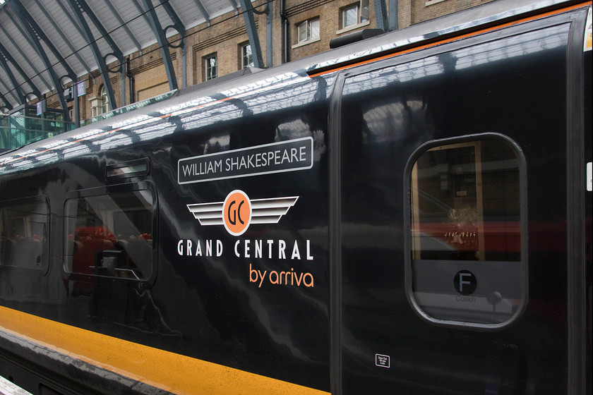 Nameplate, 180108, GC 15.50 London King s Cross-Bradford Interchange (1D93, RT), London King`s Cross station 
 Another example of the 'dumbing down' on the railways! No more classic cast nameplates, just vinyls disguised to look like their genuine counterparts! Here, 180108 displays its 'William Shakespeare' name'plate' at King's Cross. It is about to work the 15.50 Grand Central 1D93 service to Bradford Interchange. 
 Keywords: Nameplate 180108 15.50 London King's Cross-Bradford Interchange 1D93 London King`s Cross station