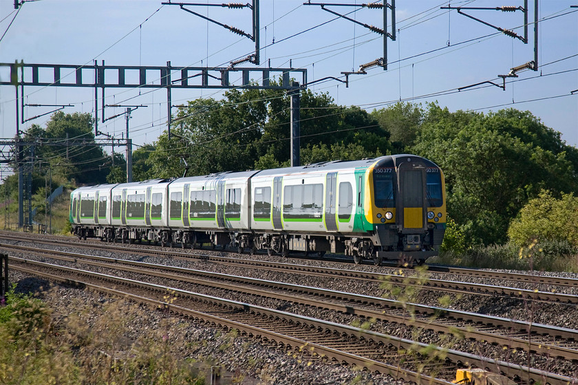 350377, LM 07.46 London Euston-Crewe (1U25), Ashton Road bridge 
 350377 takes the down fast line past Ashton Road bridge working London Midland's 07.46 Euston to Crewe. Whilst photograph in high summer can be tricky due to strong overhead lighting creating deep and dark shadows, at this time in the morning things are different. 
 Keywords: 350377 07.46 London Euston-Crewe 1U25 Ashton Road bridge London Midland Desiro