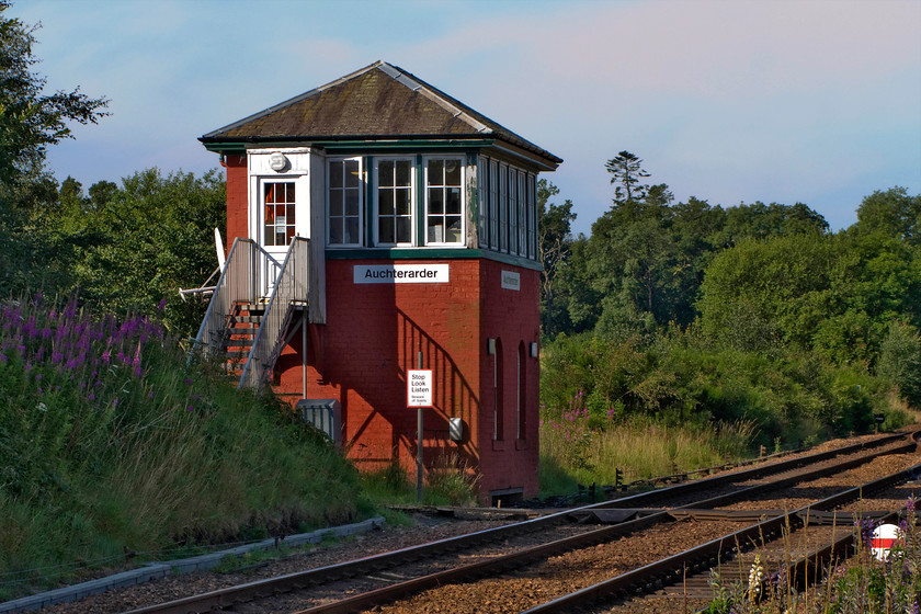 Auchterarder signal box (Caledonian, 1895) 
 Like the previous signal box, Auchterarder also took some finding! Located off a narrow country lane and up a private road leading to a car and commercial body repairs and refinishers Andy and I managed to track it down. It is a classically styled Caledonian box dating from 1895. In the bottom right-hand corner, partially concealed by the undergrowth, is the ground disc signal sixteen which could be cleared for a movement either into the siding or 'through the road' on to the Up line. However, whilst the crossover still exists, I am not sure if the siding survives? 
 Keywords: Auchterarder signal box Caledonian