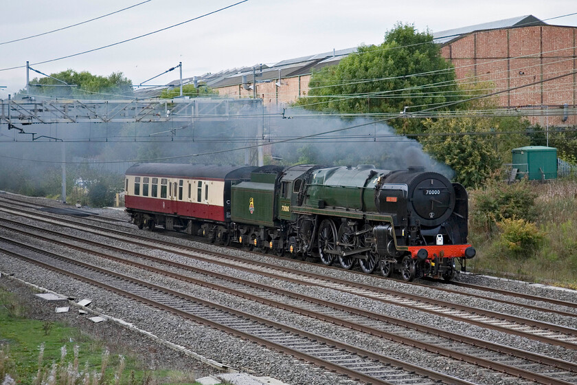 70000, Tyseley-Southall (5Z44), Roade 
 Looking very smart in its recently repainted Brunswick Green paintwork after having some significant accident damage repaired 70000 'Britannia' passes Roade. It and its support coach are heading from Tysley to WCR's Southall depot in preparation for its first mainline charter work for some time. It is scheduled to lead the Steam Dreams Cathedrals Express in two weeks so let's hope that things go to plan!

NB It did haul the charter with no issues but then went on to have a whole host of other issues over the next few years making some wonder if the locomotive was jinxed? (Note added 01.25). 
 Keywords: 70000 Tyseley-Southall 5Z44 Roade Britannia