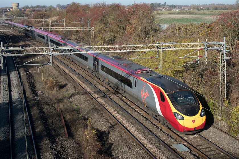 390123, VT 10.01 Preston-London Euston (1A10, 1E), Victoria bridge 
 390123 'Virgin Glory' looks smart in the late autumn sun as it passes Victoria bridge on the up slow line working the 1A10 10.01 Preston to Euston. This train took the Northampton line rather than the more usual Weedon Loop due to engineering works closing that line. 
 Keywords: 390123 10.01 Preston-London Euston 1A10 Victoria bridge