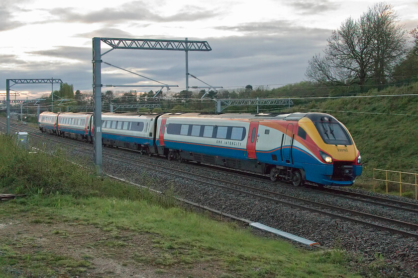 222102, EM 17.50 York-London St. Pancras (1C77, 1E), Sharnbrook Road bridge 
 By 20.30 at this time of year (mid-May) there should be enough light to take half-decent railway photographs if spots are chosen wisely. Unfortunately, on this particular evening, along with many others that characterised the spring of 2021, it was cloudy and wet with just a brief burst of illumination as seen in the background here near Souldrop in Bedfordshire. 222102 descends at speed from Sharbrook summit working the 1C77 17.50 York to St. Pancras EMR service. 
 Keywords: 222102 17.50 York-London St. Pancras 1C77 Sharnbrook Road bridge Souldrop EMR Merdian East Midlands Railway