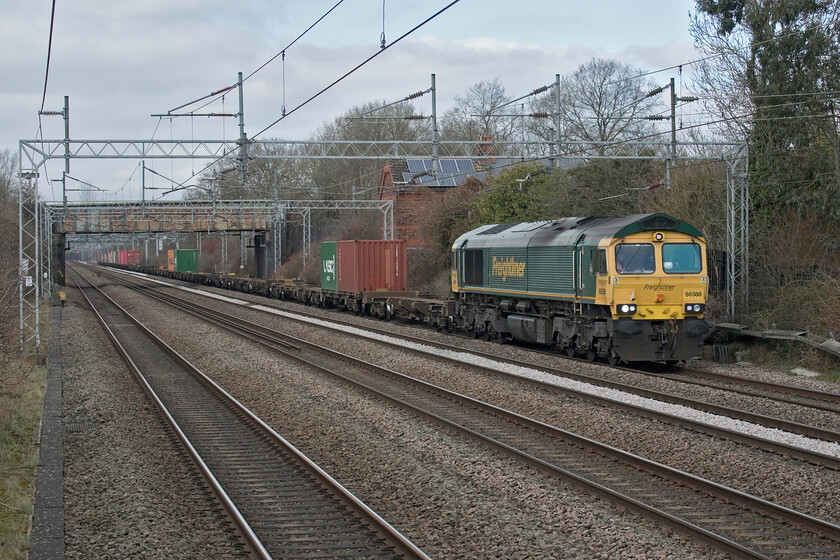 66588, 12.16 Lawley Street-London Gateway (4L46, 18E), Cathiron SP4667783 
 Freightliner's 66588 leads the 4L46 12.16 Lawley Street to London Gateway service along the up slow at Cathiron in Warwickshire. This is a classic location for the railway photographer offering wide-open views of the busy WCML Trent Valley route just north of Rugby. However, for some angles a camera with a fold-out screen is a distinct advantage as is the ability to climb on to the railing as is the case here! 
 Keywords: 66588 12.16 Lawley Street-London Gateway 4L46 Cathiron SP4667783 Freightliner