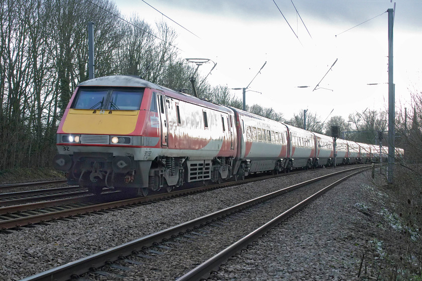 91132, GR 13.03 London King`s Cross-Leeds (1D15, 10L), Gill`s Crossing 
 Throughout railway history, there have always been cases of when some locomotives have been seen by staff as being unlucky or having some sort of curse. 91132 is one such locomotive with it leading both the trains involved in the Hatfiled (2000) and Great Heck (2001) accidents. So in the traditions of the industry, when it was rebuilt in 2001 it took the number 91132 rather than 91123 (from 91023) as it should have done thus leaving a gap in the sequence. The locomotive is seen leading the 1D15 13.03 King's Cross to Leeds past the Cambridgeshire village of Offord Cluny. 
 Keywords: 91132 13.03 London King`s Cross-Leeds 1D15 Gill`s Crossing Offord Cluny LNER