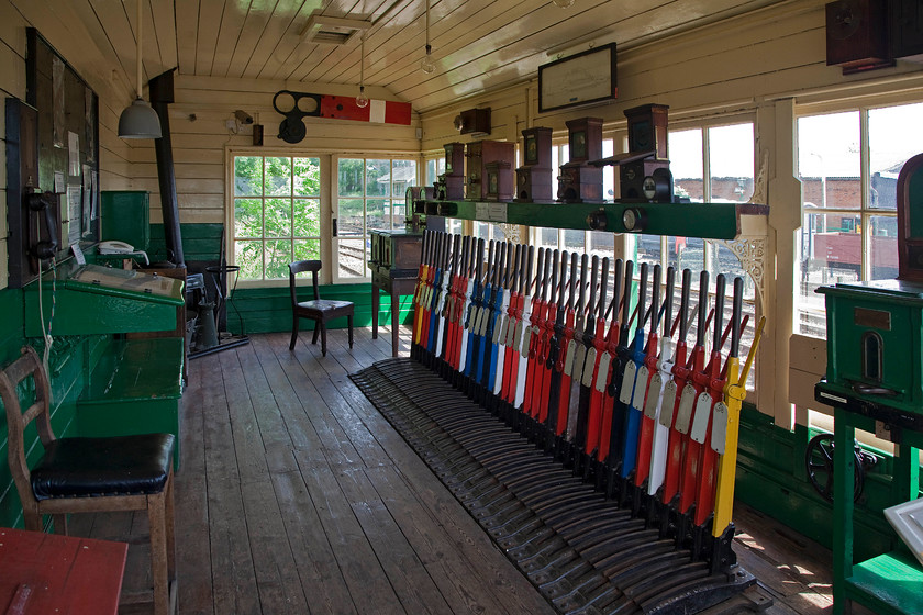 Interior, Chappel & Wakes Colne Signal Box, preserved (GE, 1891) 
 The delightful and well preserved Chappel and Wakes Colne signal box. It was opened by the Great Eastern in 1891 and has a 38-lever S&F lever frame. Unfortunately, despite being directly adjacent to running lines it performs no signalling duties being open as a museum that is part of the East Anglian Railway Museum. 
 Keywords: Chappel & Wakes Colne Signal Box, preserved GE, 1891