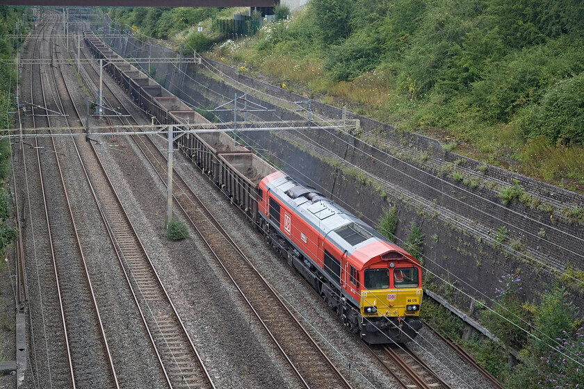 66175, 13.51 Burton-ot-Wetmoor Yard-Acton TC (6Z45, 13L), Roade cutting 
 The third named Class 66 in a row passes through Roade cutting leading the 6Z45 13.51 Burton-ot-Wetmoor to Acton Yard spoil empties. It is led by DB's 66175 'Rail Riders Express'. Looking at the wagons as they passed underneath me, it appears that an awful lot of the spoil removed from HS2 works in the London area is being returned there with a lot remaining in the wagons! 
 Keywords: 66175 13.51 Burton-ot-Wetmoor Yard-Acton TC 6Z45 Roade cutting DB Rail Riders Express