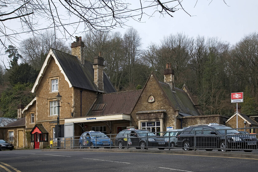 Frontage, Godalming station 
 The rather attractive frontage of Godalming station is seen in some weak spring sunshine. It was opened at this spot in 1859 as a through station replacing an earlier one slightly further north towards Farncombe that was a terminus. Nothing remains of the earlier station that is now a housing estate. Godalming is probably best known as the station used in the 2006 cult film The Holiday starring Cameron Diaz, Jude Law, Jack Black and Kate Winslet. It was renamed Shere for some days enabling the filming of a short sequence in the film. 
 Keywords: Frontage Godalming station