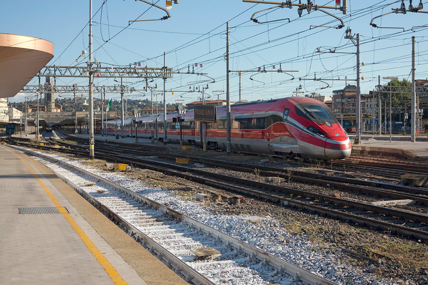 500.044, unidentified working, Florence SMN station 
 500.044, a Frecciarossa 1000 designed by Ansaldo Breda, a Finmeccanica company, in partnership with Bombardier, for the Italian TOC Trenitalia leaves Florence SNM with an unidentified working. These high speed trains number 50 and are capable of 300 Kph, the Italian highest permitted speed, in comfort and some style. 
 Keywords: 500.044 Florence SMN station