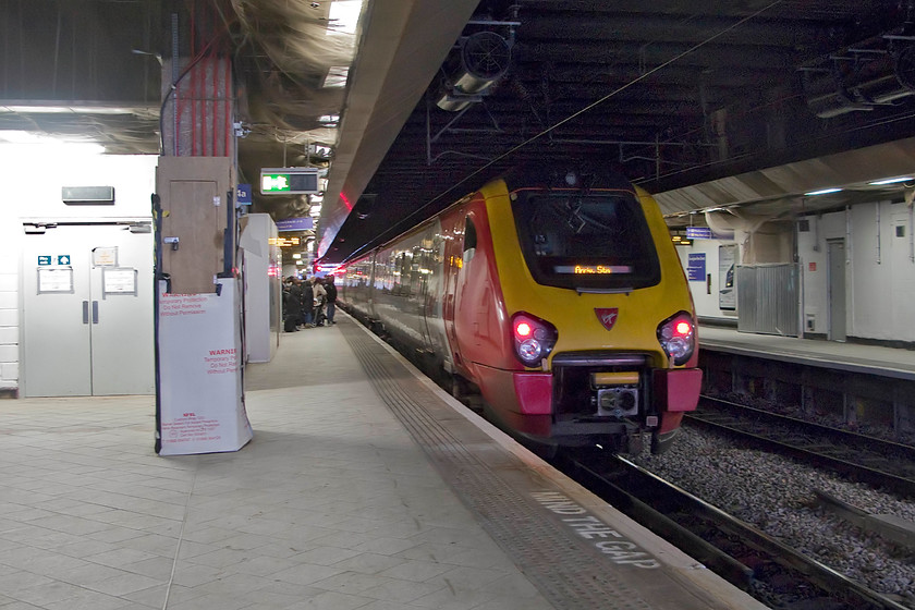 221102, VT unidentified up working, Birmingham New Street station 
 I never did discover what this Virgin Voyager was working. It was locked and out of use with the display saying, rather unhelpfully, 'Arrived Station'. 221102 'John Cabot' stands inside New Street with much evidence to the left of the train of the extensive re-build that the station was undergoing. 
 Keywords: 221102 unidentified up working Birmingham New Street station