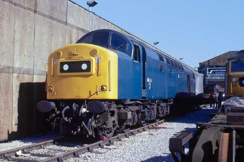 40157 & 47448, awaiting attention, Crewe Works 
 Basking in the sun at Crewe Works is 40157 looking very smart. It had been at the works since the end of July and did not leave until the end of November after receiving engine and 'rectification' repairs. It survived in service until July 1983 failing at Carstairs whilst working the 11.03 Stirling to Euston with a main generator flashover. It was cut up at Doncaster during the autumn of the same year. 47448 was Crewe built in 1964 and survived until being stored by 1996 after ending its days as a parcels sector locomotive. 
 Keywords: 40157 47448 Crewe Works