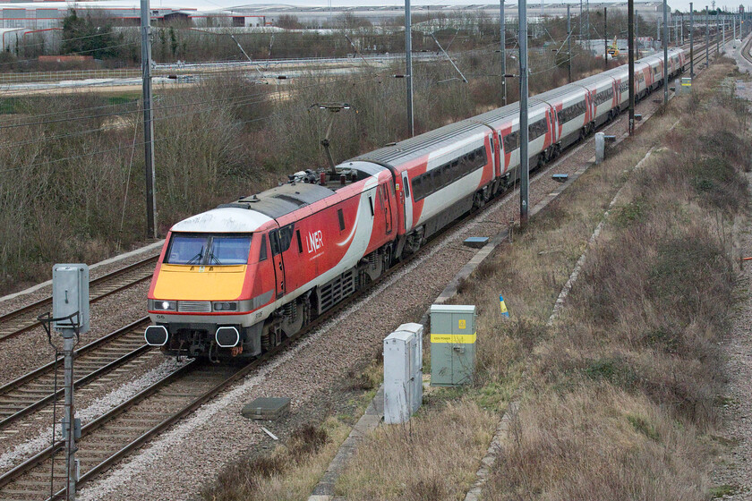 91106, GR 10.33 London King's Cross-Leeds (1D10, RT), Marholm TF154036 
 Despite LNER's efforts to oust locomotive haulage from the ECML and even with it running a seventy-five per cent COVID timetable it still does not have a high enough Azuma availability to replace them all. In fact, at the time of writing in the winter of 2022, there remain five locomotive-hauled diagrams making twenty-eight services a day operating using the superb Mk.IV stock dating from the late 1980s. With the reduced timetable some of these diagrams are Azuma operated but with LNER's stated aim to return to a full timetable very soon I suspect that the full five diagrams will return to locomotive-hauled sets again. Having worked up in the morning as the 06.56 from Skipton it heads north again as the 1D10 10.33 King's Cross to Leeds diagram five being worked by 91106 and with DVT 82229 on the rear. One can only speculate as to how long LNER will operate these services so get your photographs whilst you can! 
 Keywords: 91106 10.33 London King's Cross-Leeds 1D10 Marholm TF154036 IC225 LNER Class 91