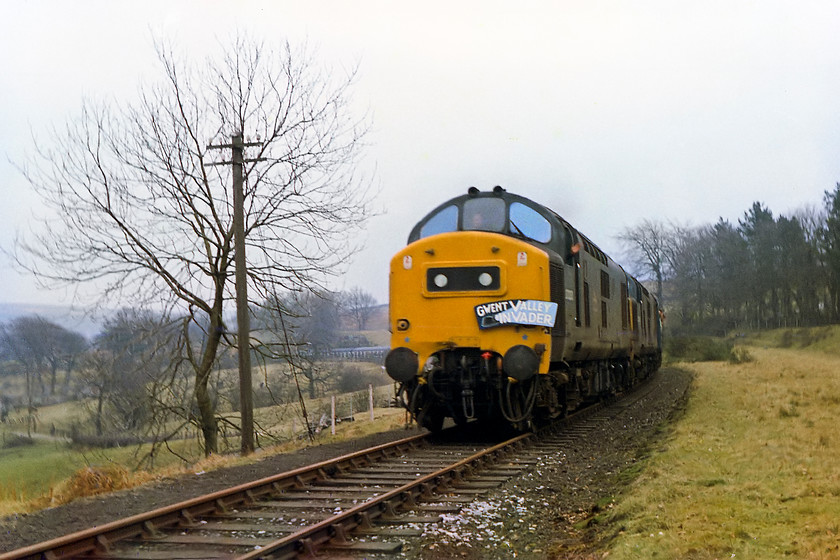 37233 & 37269, outward leg of The Gwent Valley Invader, Crewe-Blaenavon (1Z46), Blaenavon SO254080 
 As 37233 and 37269 approach Blaenavon with the Gwent Valley Invader railtour the driver extends a friendly wave probably being quite relived that he's got his train up and round all the curves to the end of the line at the colliery! The train has just climbed 1 100 feet from Newport, a journey of just over 16 miles that has taken an hour and ten minutes! Looking at the state of the track, no trains had traversed the line for some time. There is no track now except for a couple of miles at the old colliery that is run by the Pontypool and Blaenavon heritage railway. However, the route of the line is now one of Sustrans National Cycle Network routes, number 492. 
 Keywords: 37233 37269 The Gwent Valley Invader Crewe-Blaenavon 1Z46 Blaenavon SO254080