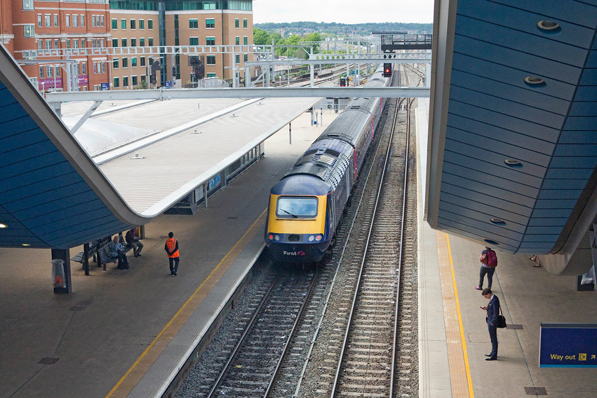 43086, GW 13.15 London Paddington-Cardiff Central (1B37), Reading station 
 The sweeping roofs that cover the pedestrian access to the platforms from the station bridge at Reading's new station are one its most notable features. With the extra wide bridge, complete with retail facilities, the station is more akin to an airport than a railway station! 43086 is seen taking up the rear of the 13.15 Paddington to Cardiff Central. 
 Keywords: 43086 13.15 London Paddington-Cardiff Central 1B37 Reading station