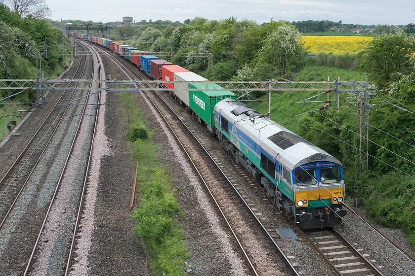 66711, 14.12 Trafford Park Felixstowe North (4L18), Victoria bridge 
 Hot on the heels of the previous up freight, just six minutes later was 66711 'Sence' leading the 14.12 Trafford Park to Felixstowe North, so far, the most heavily loaded of the three up Freightliner's observed. This GBRf 66 is in a particularly striking livery, being painted in Aggregate Industries' blue, green and silver, with a green and blue Aggregate Industries logo. This represents the close working relationship that GBRF Aggregate Industries have developed, even though the loco. is not employed on these duties here at Victoria bridge! 
 Keywords: 66711 14.12 Trafford Park Felixstowe North 4L18 Victoria bridge