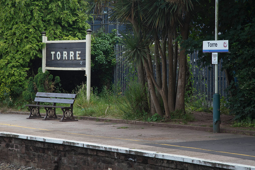 Running-in boards & bench, Torre station 
 Reproduction running-in board and benches are popular features of stations and they certainly add a little character. Notice the palm trees growing healthily, a tree that is found commonly throughout the English Rivera as Torbay likes to call itself. 
 Keywords: Running-in boards & bench Torre station