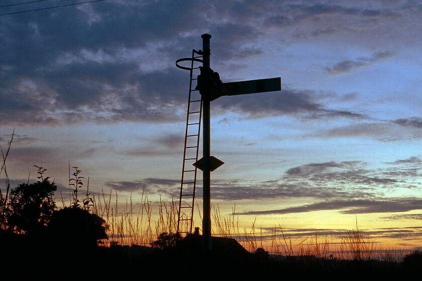 Up home signal, Codford 
 Silhouetted against a lovely late summer evening sky after the sun has just set Codford's up home signal is seen. I do not quite understand how and why I did not get myself to the delightful Wylye valley more than just this once to photograph trains as it was so local to home being just a half an hour or so drive. With the removal of the semaphore signalling and the closure of the boxes less than a year after this photograph was taken it will have a lost a little of its magic! 
 Keywords: Up home signal Codford