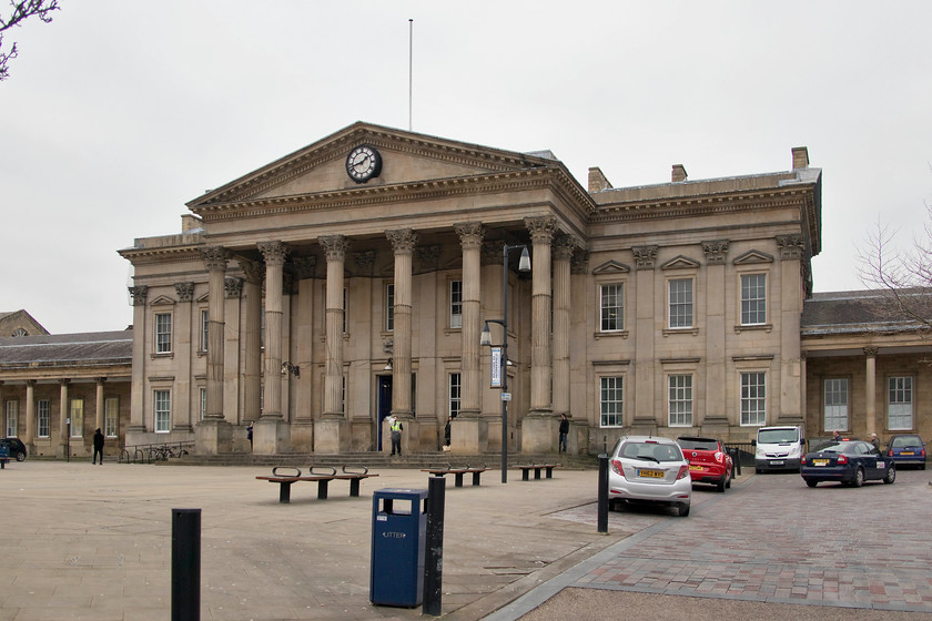 Frontage, Huddersfield station 
 The frontage of Huddersfield station presents an imposing and grand image for what is, after all, just a railway station! It was designed by the architect James Pigott Pritchett and built by the firm of Joseph Kaye between 1846 and 1850 to the neo-classical style. It is a Grade I listed structure and it dominates St. George's Square where it is situated. The London and North Western Railway opened the station in 1847 to serve the hugely important town and community of West Yorkshire. To the far right of the picture is Andy's Nissan Micra, somewhat dwarfed by the building it's parked in front of!