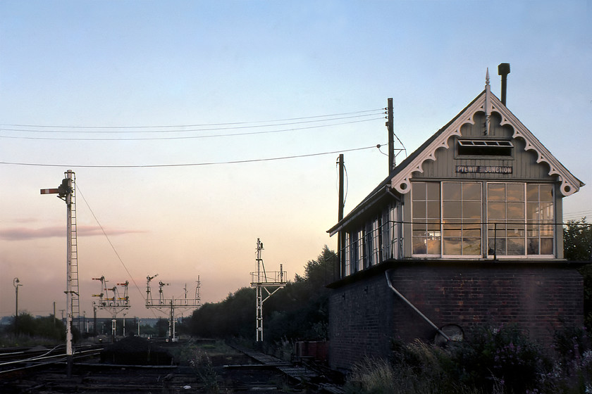 Pyewipe Junction signal box (GN, date not known) 
 This was a very eerie place to be at dusk on a late summer's evening! I am not sure how Graham and I managed to get this close to Pyewipe Junction and its associated signal box but it did enable me to take this very atmospheric photograph looking east back towards Lincoln. The area was once home to an extensive area of sidings and a large shed that was jointly run an operated by various railway companies such as the GN, the GN & GE Joint and the Great Central. The facing bracket with three dols permitted trains to enter Lincoln to the left, enter the former shed sidings or via the former Joint avoider route to Greetwell Junction to the right. The twin dolls on the bracket to the right are the homes for either the route to Doncaster (via Gainsborough) or the former GC route to the Midlands via Clipstone Junction. Most of this latter route is now closed and the tracks lifted but for the section of test track at High Marham. Note that a train is pegged for the Doncaster route. The box is superb Great Northern structure but I have no date for its construction. I have read reports from signalman that this was an incredibly quiet place to work surrounded by flat land and bird song but it was a tricky box to operate described a 'bit of brain teaser'*. It was certainly very atmospheric when we visited as seen in this photograph!

* https://www.photrek.co.uk/?page_id=974 
 Keywords: Pyewipe Junction signal box Great Northern Railway GNR