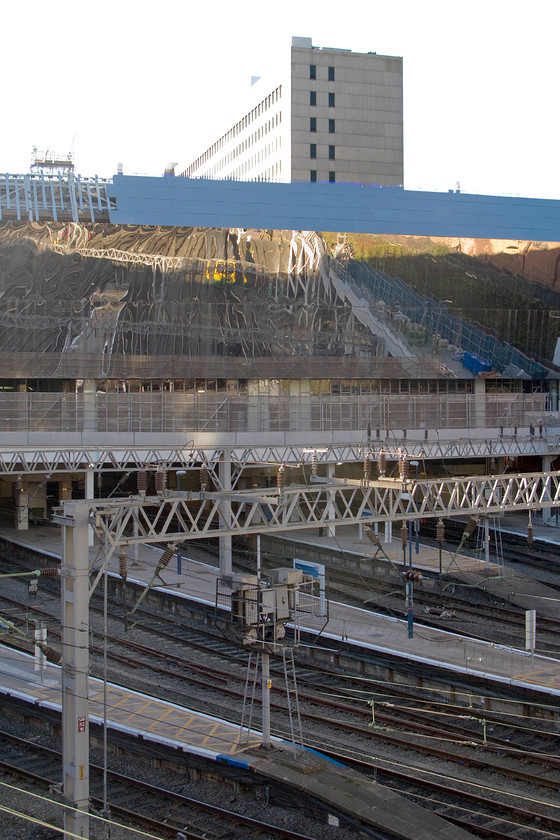 Class 323, reflected in new cladding, Birmingham New Street station 
 A view of New Street's platform ends from the pedestrian walkways that surround the station. The view shows the somewhat controversial stainless steel cladding that is being attached to the outside of the new building. Reflected in the cladding, is a class 323 leaving the station. 
 Keywords: Class 323 Birmingham New Street station