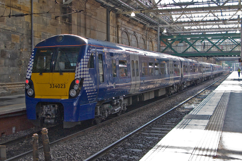 334023, stabled, Edinburgh Waverley station 
 334023 sits in the afternoon sunshine stabled at Edinburgh Waverley station. I am not sure about the design and looks of the Alstom built units that are part of the Juniper family. Introduced on the Clyde coast route in 2001 they are about to go through a huge overhaul programe, I wonder when they return from this if they will keep their oversized front numbers? 
 Keywords: 334023 Edinburgh Waverley station