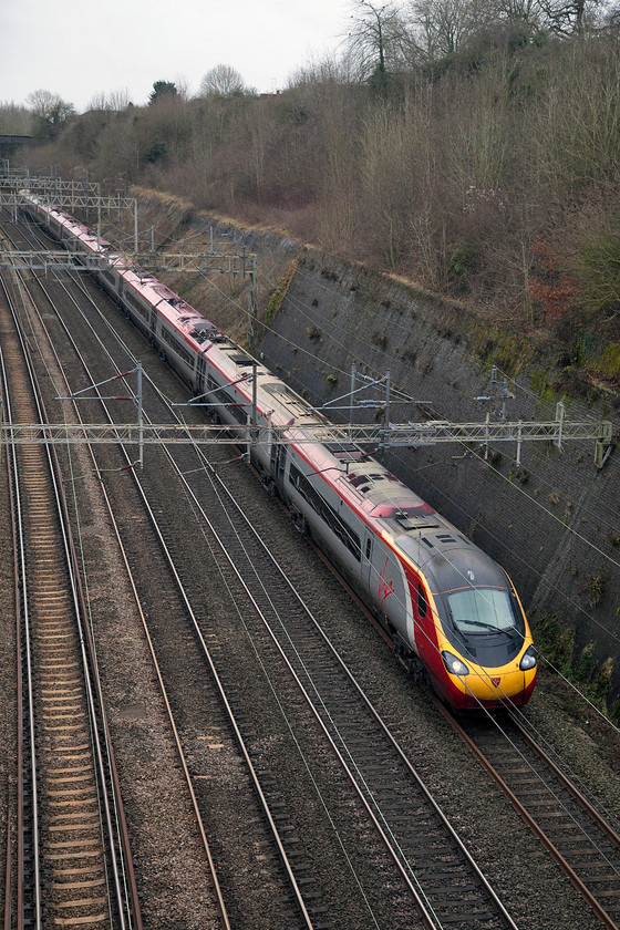 390122, VT 12.20 London Euston-Birmingham New Street (9G12, 1L), Roade Cutting 
 390122 'Penny the Pendolino' takes Roade Cutting heading north with the the 9G12 12.20 Euston to Birmingham new Street working. A very wintery scene with leafless trees, very flat colour and dull lighting. 
 Keywords: 390122 12.20 London Euston-Birmingham New Street 9G12 Roade Cutting