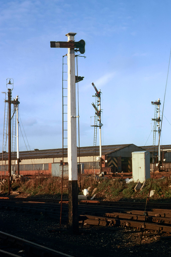 Signals, Cricklewood yard 
 With Cricklewood depot in the background, a superb collection of mechanical signalling is in full view. Dominating the scene is a superb Midland Railway wooden post, with no finial, that has a fluted metal upper quadrant arm. All this superb signalling would be wiped away over the coming two years as the line was upgraded and electrified. 
 Keywords: Signals Cricklewood yard