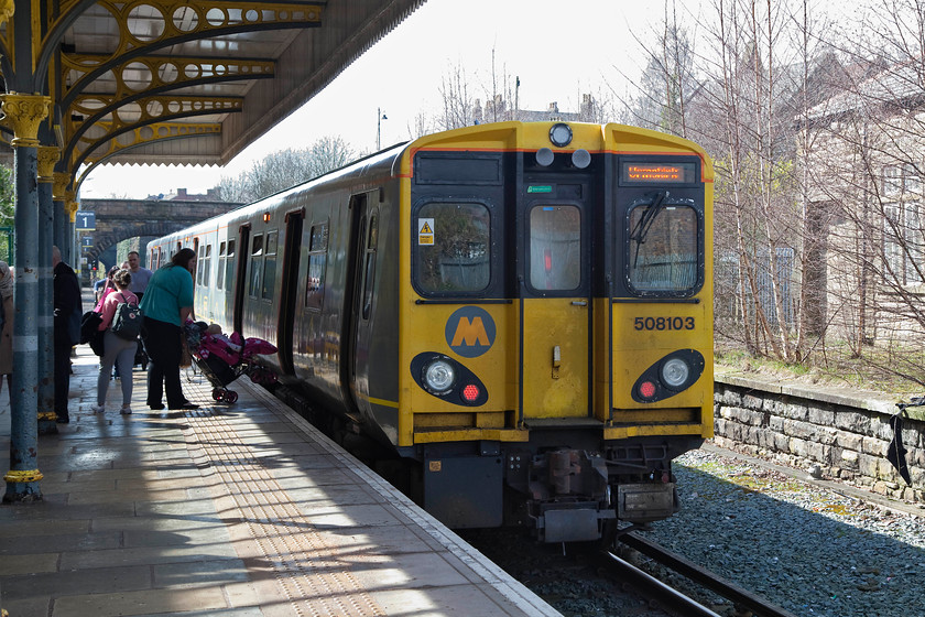 508103, ME 12.10 Liverpool Central-Orsmkirk (2O24, RT), Ormskirk station 
 508103 stands at Ormskirk having just arrived with the 12.10 from Liverpool Central. I travelled on this train and experienced, yet again, an example of Merseyrail's heavy handed customer relations. Some years ago I remember reading an article in Rail where they followed one of Merseyrail's travelling enforcement 'teams' - how I hate the overuse of that term! It read as if they were doing a great job and was very positive and supportive of passengers. However, I witnessed three of them in actin on this service and it was far from what I read in Rail. Indeed, it was more akin to some Cold War Eastern European Special police unit! They walked along the train in a group all kitted and 'cameraed' up demanding to see tickets with no more of a grunted request. They then stood in the vestibule area close to me watching the goings on in the carriages. They also watched passenger at stations and went so far as audibly commenting on one individual crossing the footbridge at Town Green station. It was all very unpleasant and intimidating. Perhaps Merseyrail should invest in station barriers and staff at all staions if they are so concerned about fare dodgers rather than 'heavies' patrolling their trains. 
 Keywords: 508103 2O24 Ormskirk station