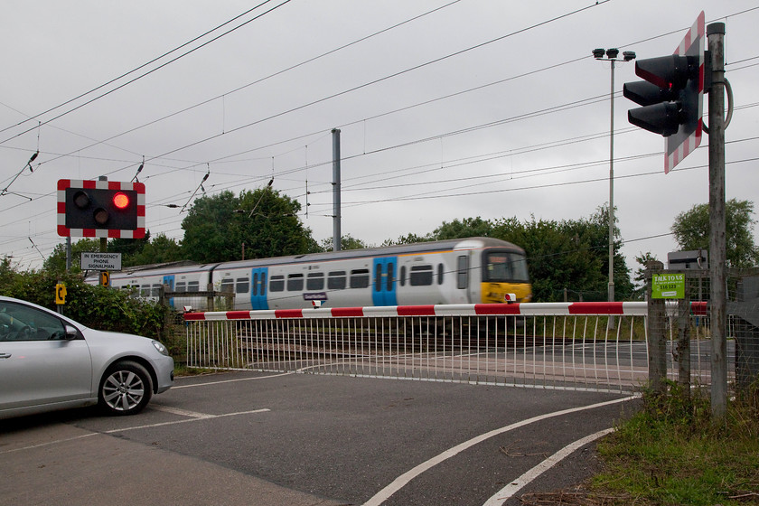 Class 365, GN 08.34 London Kings Cross-Peterborough (2P06, RT), Tempsford Crossing 
 Tempsford level crossing barriers are down as an unidentified class 365 passes on the down slow with the 08.34 King's Cross to Peterborough. Unlike the next crossing south, Everton, this one is on a quiet road that leads to a couple of isolated farms and creates very few problems for road users. The queues at Everton can become significant, particularly at peak times. 
 Keywords: Class 365 2P06 Tempsford Crossing