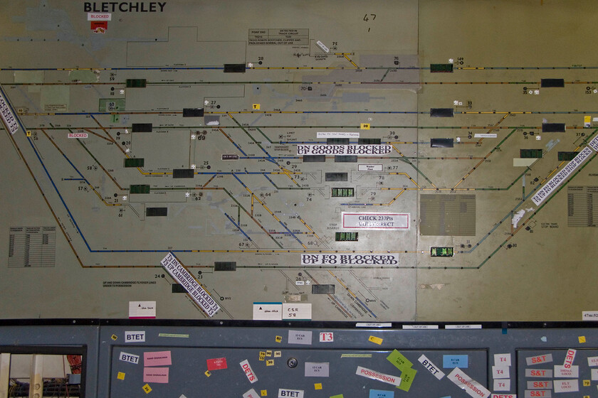 Track diagram, Bletchley PSB 
 The track layout in the Bletchley station and yard area is seen but with the power off no lights illumonation showing the various aspects of the signals. This diagram is the same as the one that us local enthusiasts use day to day on OpenTrainTimes but our version is very much cut down and definitely with none of the various annotations seen on the board. Of note here is the annotation to the lower left stating 'Down and Up Cambridge blocked'. The Varsity line between Oxford and Cambridge has been closed as a through route for many years but the legacy of its existence is still plain to see. 
 Keywords: Track diagram Bletchley PSB