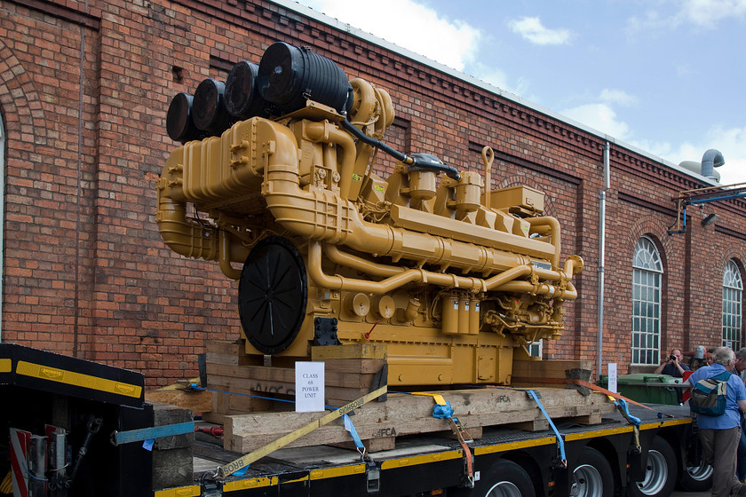 Class 68 power unit, on-display, DRS Gresty Bridge 
 A power unit from a class 68 on-display at Gresty Bridge open day. The engine (referred to as a prime mover in today's parlance) is made by Caterpillar hence painted in this, their house colour. The C175 16-cylinder 3 800hp diesel Engine is claimed to give an incredible 7.5 million running hours. 
 Keywords: Class 68 power unit DRS Gresty Bridge